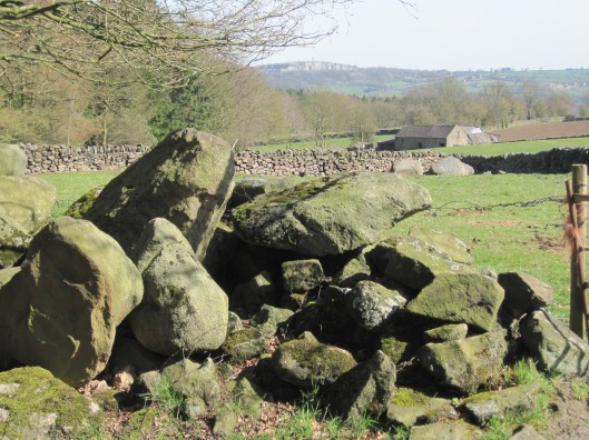 Here you have it all: large stones in the foreground, then a stone wall with a stone barn, and Crich quarry on the horizon